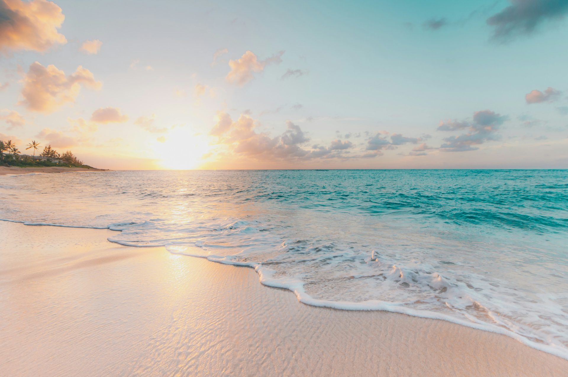 Sunset over a calm turquoise beach