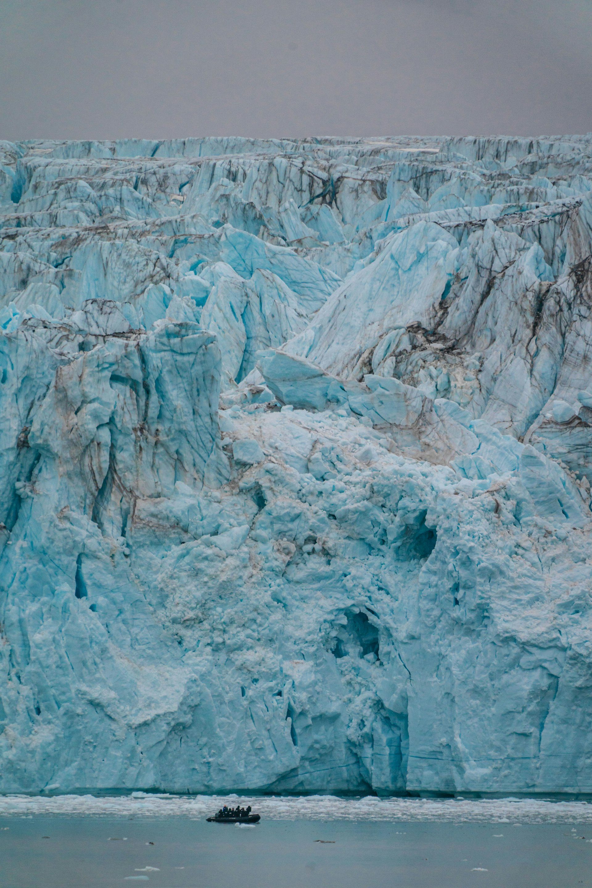 A zodiac beside glacier ice