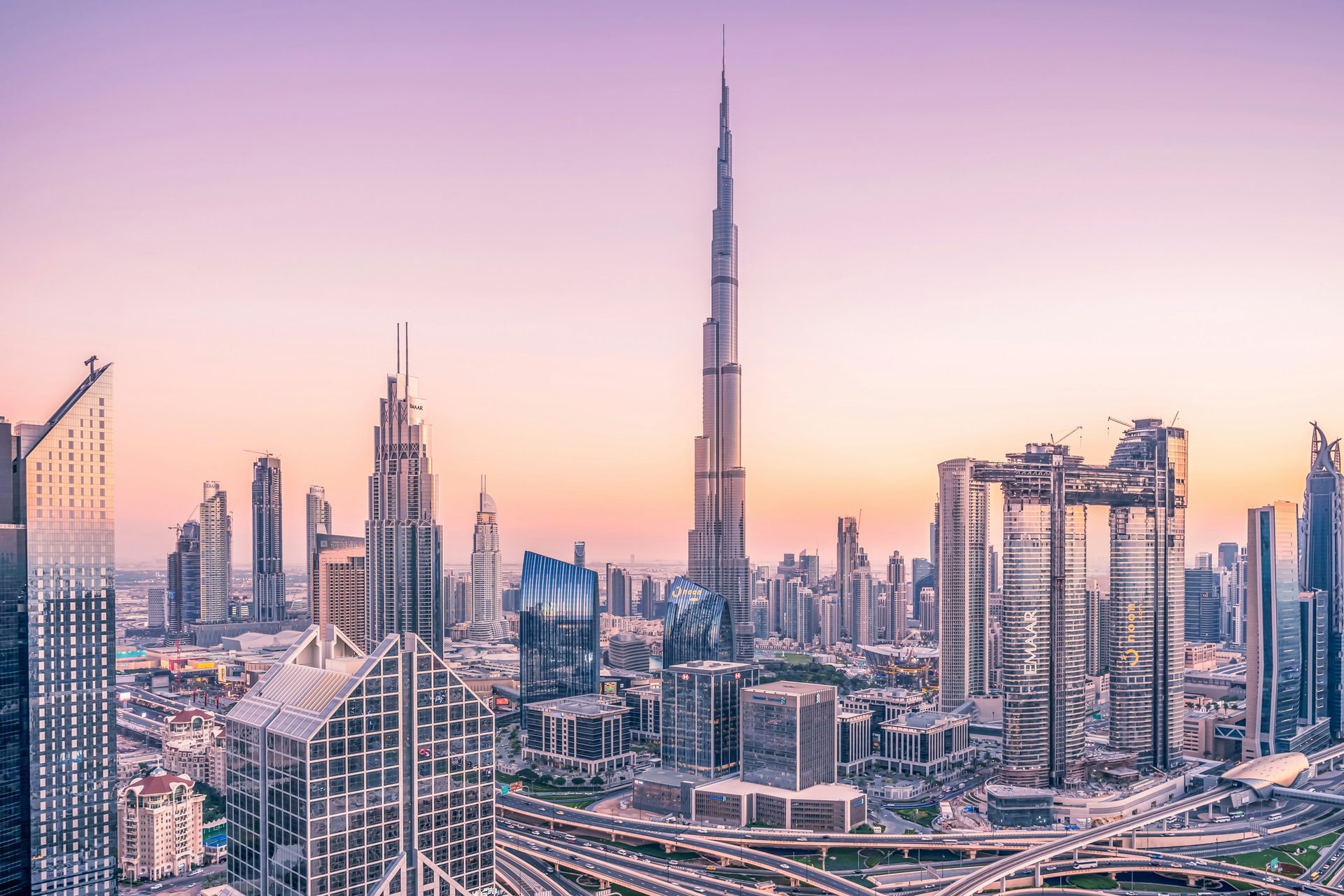 A city skyline at sunrise in pink light