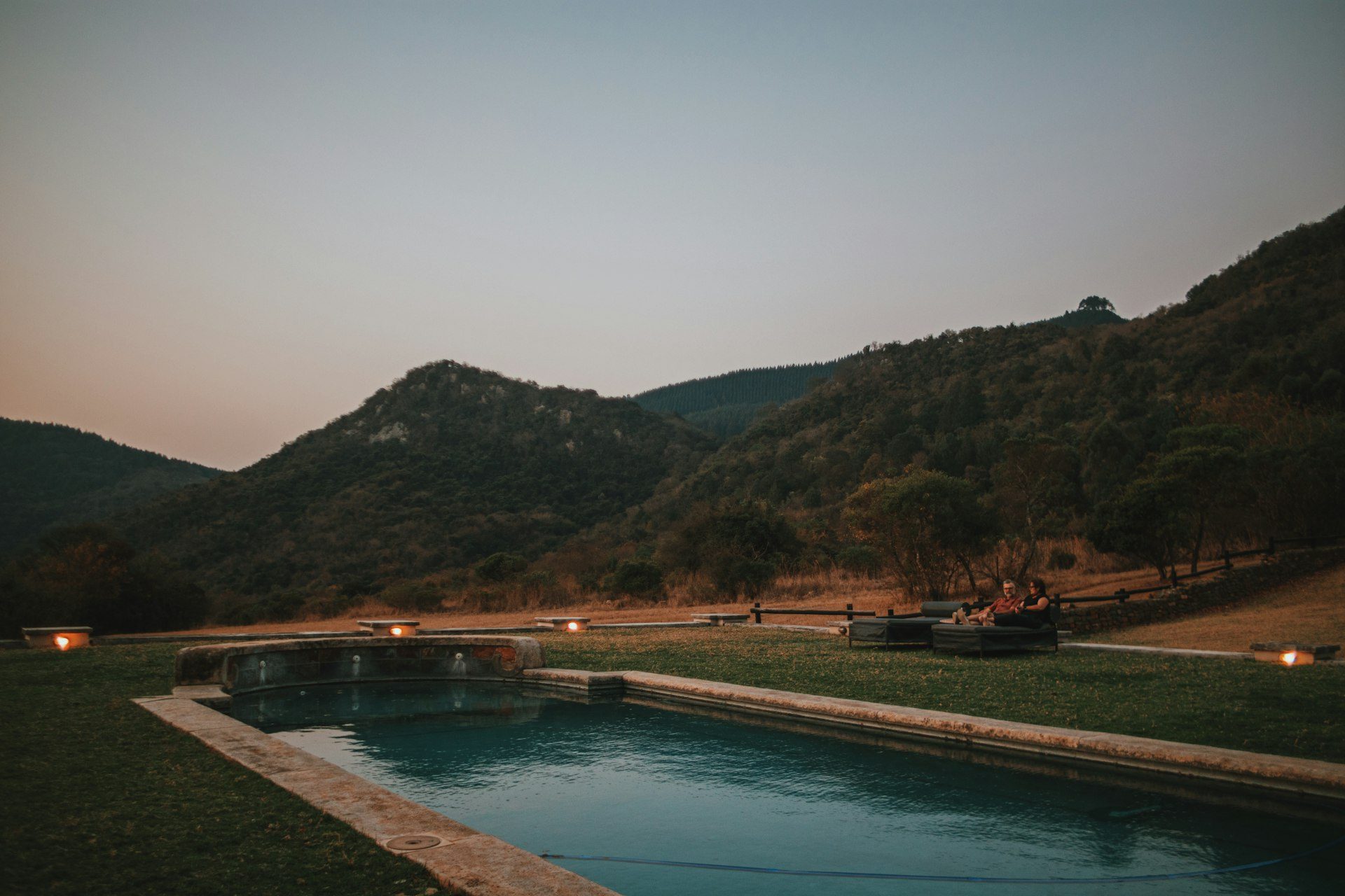 A lantern-lit safari camp at dusk