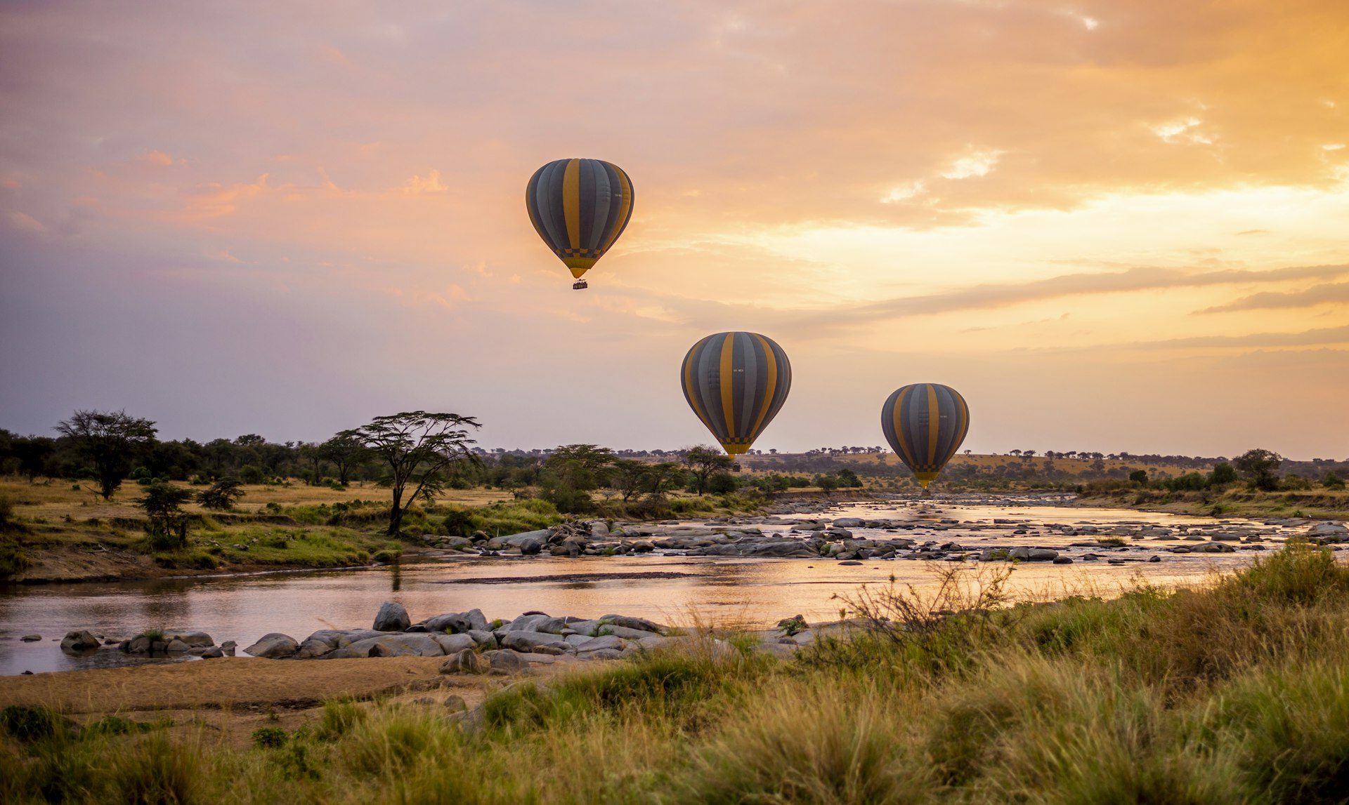 A balloon drifting over the plains at dawn