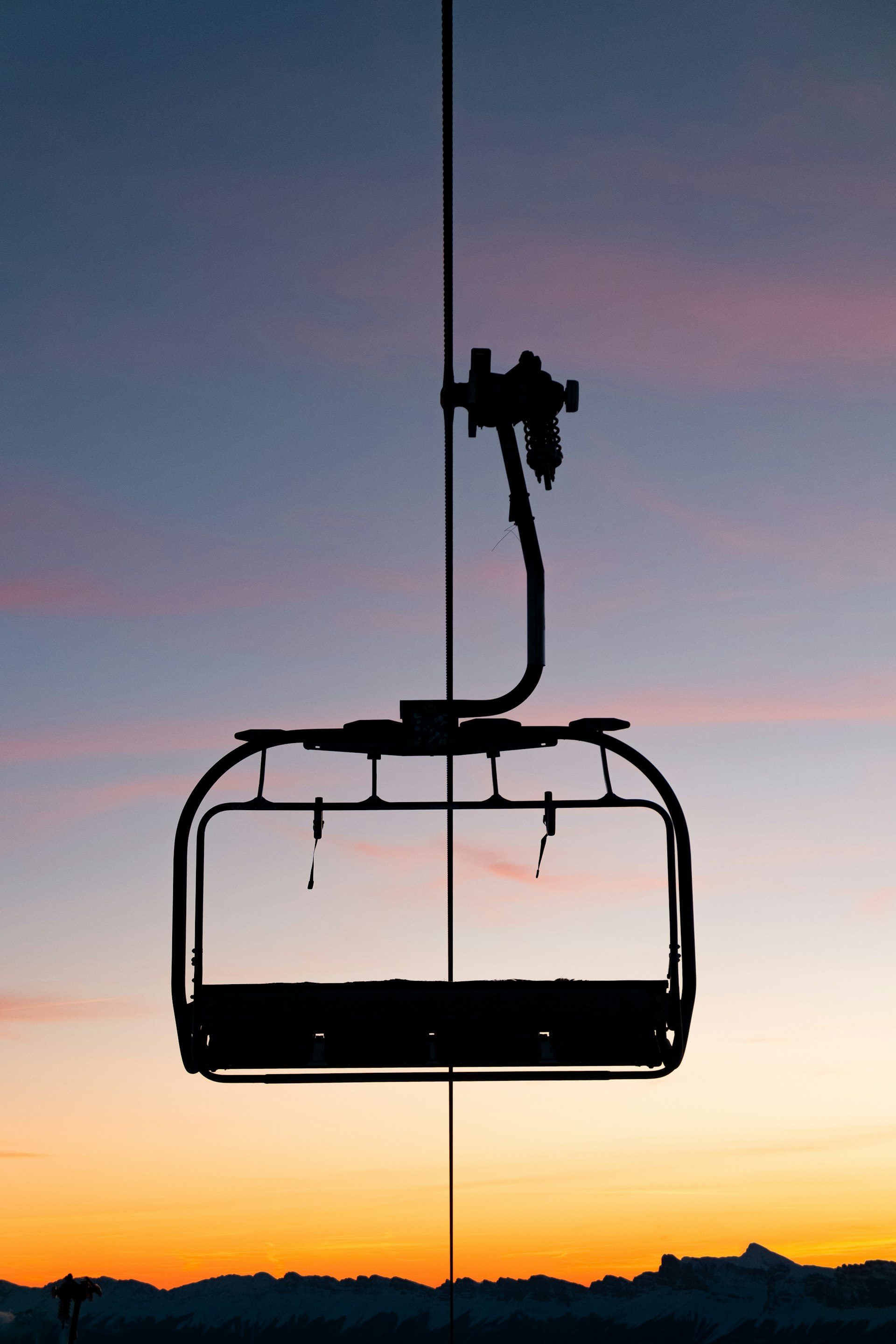 A gondola rising through alpenglow